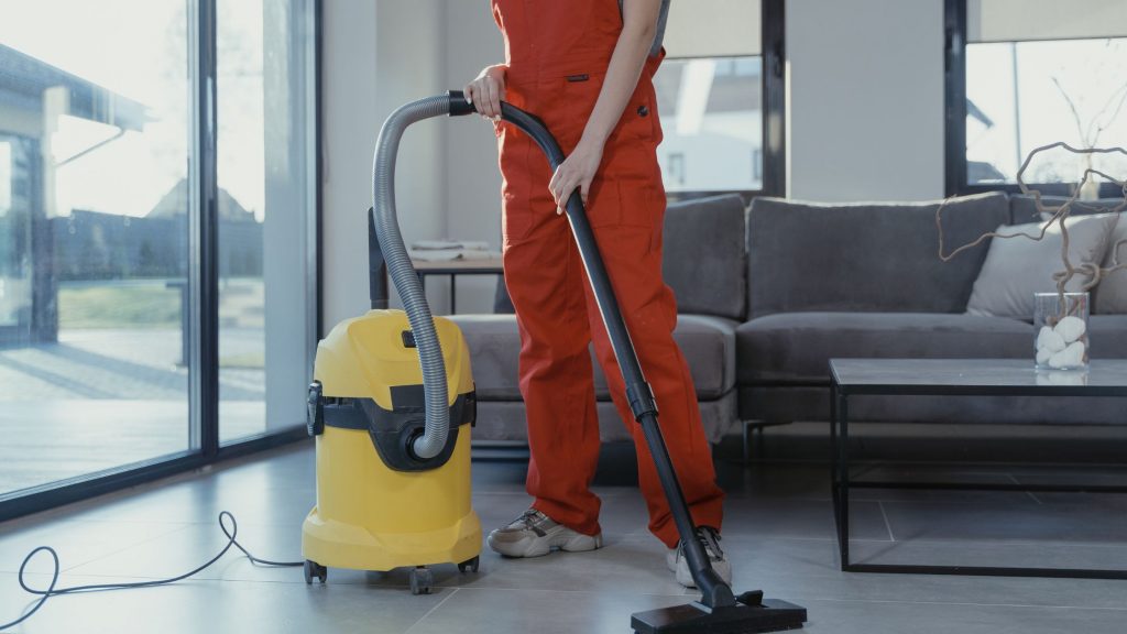 Image of yellow commercial vacuum cleaner being used for Commercial Vacuum vs Residential Vacuum Cleaners